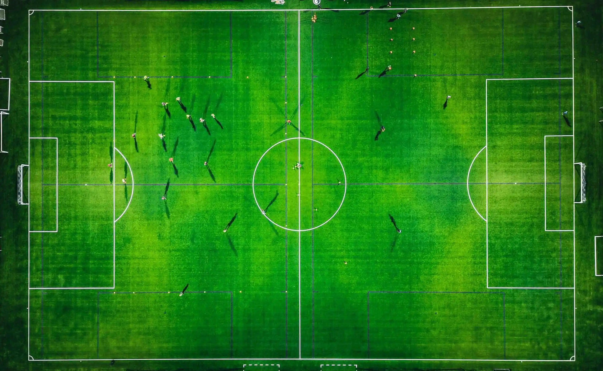 Top-down view of a soccer match on a green field
